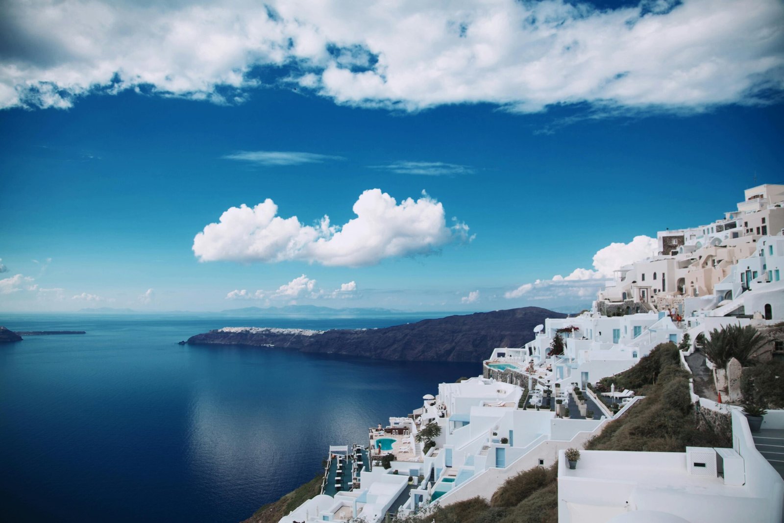 Breathtaking panoramic view of Santorini's white-washed architecture against the deep blue sea.